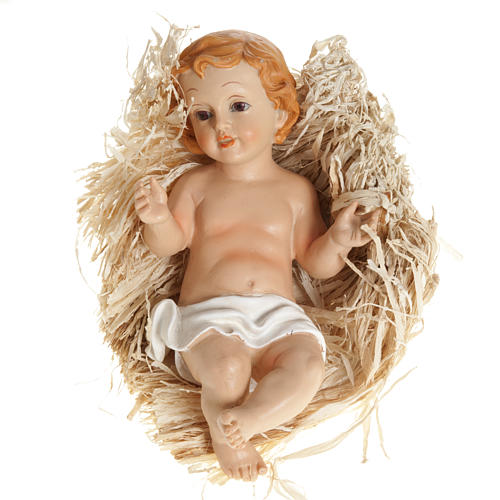 Baby Jesus figurine in pvc laying on straw