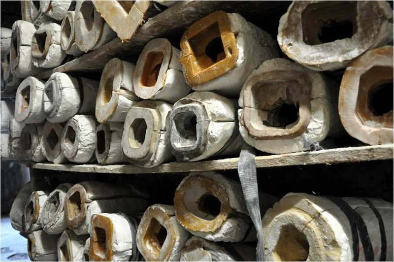 The molds of the statues laid out on shelves