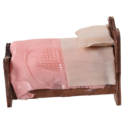 Wooden bed with sheets and fabric blanket 10 cm